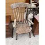 A HIGH BACKED FARMHOUSE ARMCHAIR