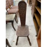 AN EARLY 20TH CENTURY OAK HEAVILY CARVED SPINNING CHAIR WITH FOLIATE DECORATION