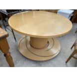A SKOBVY DINING TABLE, 47" DIAMETER, WITH TURNTABLE EXTENSION SYSTEM OF THREE LEAVES