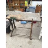 A WORK BENCH ON A CAST IRON BASE WITH A P & B WOOD VICE