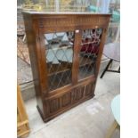 A PRIORY STYLE OAK GLAZED AND LEADED BOOKCASE WITH LINENFOLD CUPBOARDS TO THE BASE, 38" WIDE, 54"