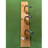 A WOODEN COAT RACK UTILISING GOLF CLUBS AS THE HOOKS