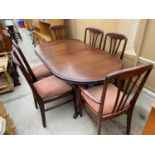 A MAHOGANY EXTENDING DINING TABLE WITH FOUR CHAIRS AND TWO CARVERS
