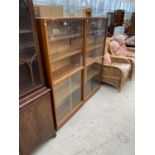 TWO TEAK BOOKCASES EACH WITH FOUR SLIDING GLASS DOORS