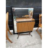 A DROP-LEAF FORMICA TOP KITCHEN TABLE AND BLACK FRAMED BEVEL EDGED MIRROR, 44x34"