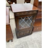 A PRIORY STYLE OAK CABINET WITH LOWER DOOR AND UPPER LEAD GLAZED DOOR