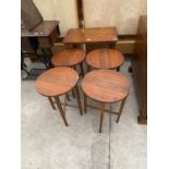 A RETRO TEAK OCCASIONAL TABLE ENCLOSING FOUR ROUND TEAK DROP-LEAF TABLES