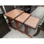 A G-PLAN NEST OF THREE TEAK TABLES WITH HAMMERED COPPER TOPS