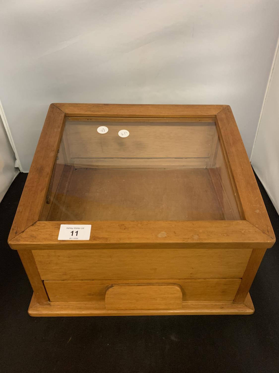 A WOODEN COUNTER TOP DISPLAY CABINET WITH SINGLE DRAW