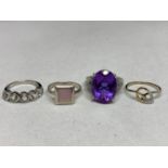 FOUR ASSORTED SILVER RINGS WITH PINK, PURPLE AND CLEAR STONE EXAMPLES