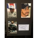 THREE PHTOGRAPHS OF LEWIS HAMILTON WITH HIS AUTOGRAPH IN A MOUNT COMPLETE WITH CERTIFICATE OF