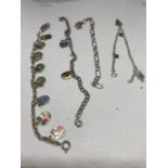 FOUR SILVER BRACELETS WITH VARIOUS CHARMS