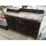 A LARGE VINTAGE WORK BENCH WITH EIGHT DRAWERS AND STORAGE CUPBOARD