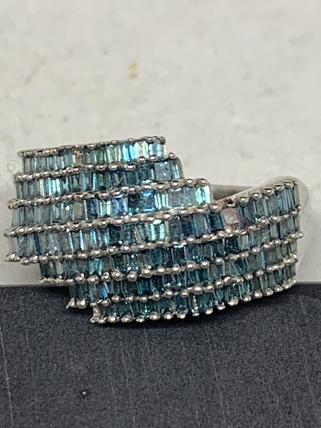 A 9 CARAT WHITE GOLD RING WITH PALE BLUE STONES SIZE I/J