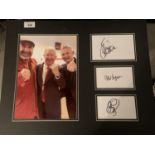 A PHOTOGRAPH OF ALEX FERGUSON, OLE GUNNAR SOLSKJAER AND ERIC CANTONA WITH THEIR AUTOGRAPHS IN A