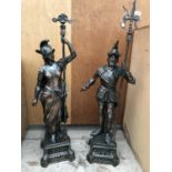 A LARGE PAIR OF METAL BRASS EFFECT FIGHTING WARRIORS, SLIGHT FAULT TO FEMALE STATUE