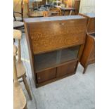 AN OAK BUREAU WITH FALL FRONT AND FOUR SLIDING DOORS