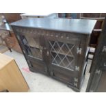 A PRIORY STYLE OAK CABINET WITH TWO LOWER DOORS AND TWO LEAD GLAZED DOORS