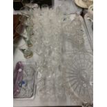 A LARGE QUANTITY OF GLASSWARE TO INCLUDE CUT GLASS PLATES AND WINE GLASSES