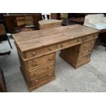 A PINE TWIN PEDESTAL DESK WITH NINE DRAWERS