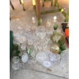 A LARGE COLLECTION OF GLASS WARE TO INCLUDE FRUIT BOWLS, DECANTORS ETC