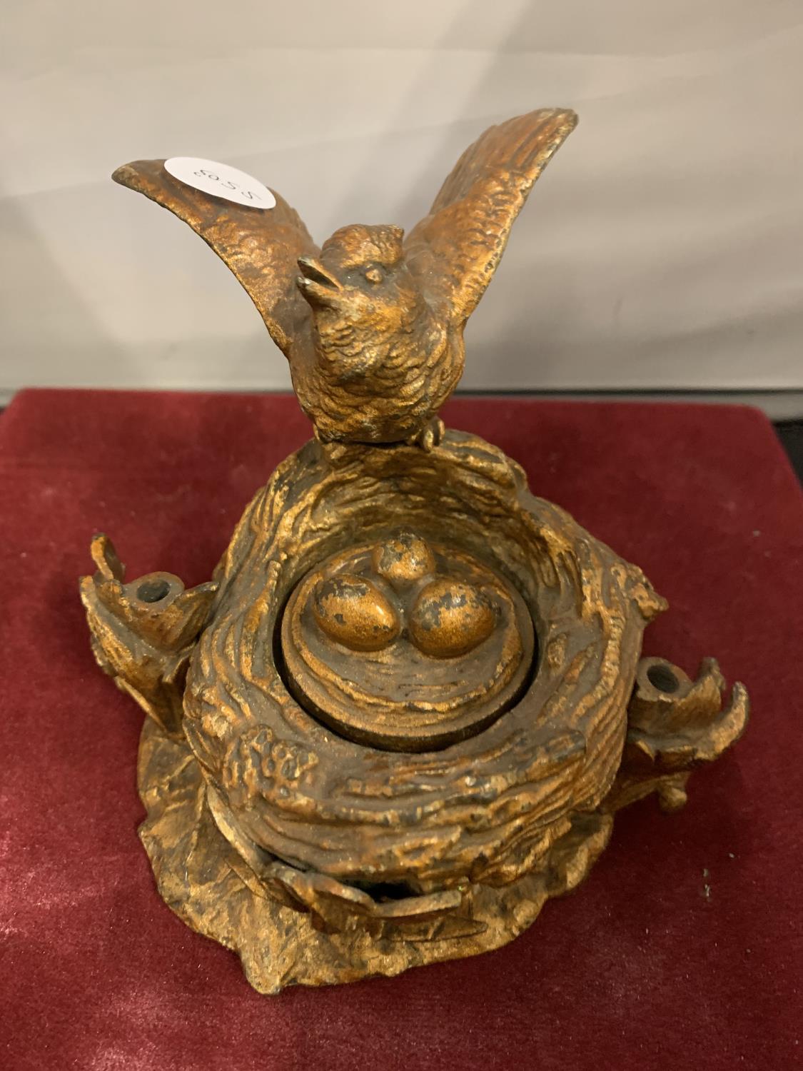 A LATE 19TH CENTURY PAINTED BRONZE INKWELL IN THE FORM OF A BIRD AND BIRD NEST WITH EGGS