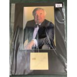 A MOUNTED PHOTOGRAPH OF JIMMY TARBUCK OBE WITH AUTOGRAPH