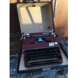 A VINTAGE OLYMPIA TYPEWRITER WITH CARRY CASE