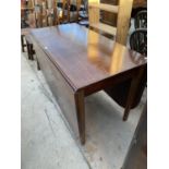 AN OAK DROP LEAF DINING TABLE