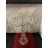 A VINTAGE GLASS THREE CANDLESTICK WITH DROP GLASS DETAIL