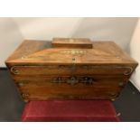 A VINTAGE WOODEN TRAVELLING DRINKS CASE WITH DECORATIVE BRASS IN LAY