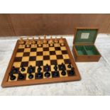 A SET OF STAUNTON CHESSMEN IN A LOCKABLE MAHOGANY CASE WITH KEY TOGETHER WITH A WOODEN CHESS BOARD