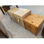 TWO BEECH EFFECT BEDSIDE CHESTS AND A PINE BEDSIDE CHEST