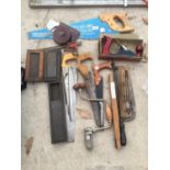 VARIOUS VINTAGE HAND TOOLS TO INCLUDE A PLANE, HAND SAWS, STONE SHARPENER, TAPE MEASURES ETC.