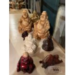 EIGHT CERAMIC BUDDHA ORNAMENTS OF VARYING SIZES