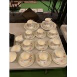 AN ASSORTMENT OF CERAMIC WARE TO INCLUDE TEN MATCHING TRIOS AND FURTHER CUPS AND PLATES ETC