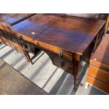 A 19TH CENTURY MAHOGANY KNEEHOLE DESK ENCLOSING THRE DRAWERS, ON TURNED LEGS, 39" WIDE
