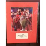 A PHOTOGRAPH OF MOHAMED SALAH WITH HIS AUTOGRAPH IN A MOUNT COMPLETE WITH CERTIFICATE OF