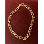 A 14 CARAT GOLD BRACELET WITH COLOURED STONES 6.2G