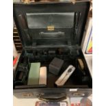 A VINTAGE MOBILE BARBERS CASE CONTAINING HAIRDRESSERS ACCESSORIES