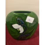 AN UNUSUAL SHAPED ANITA HARRIS SIGNED AND HAND PAINTED GREEN VASE WITH A LILY DESIGN