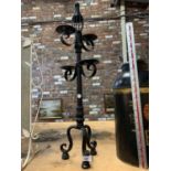 A LARGE HEAVY METAL CANDLE HOLDER, 81CM TALL.