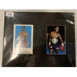 TWO MOUNTED COLOUR PHOTOGRAPHS, ONE SIGNED, OF MIDDLEWEIGHT BOXER NIGEL BENN COMPLETE WITH