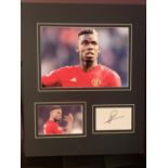 TWO PHOTOGRAPHS OF PAUL POGBA WITH HIS AUTOGRAPH IN A MOUNT COMPLETE WITH CERTIFICATE OF