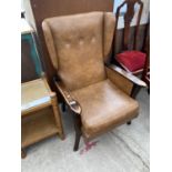 A MAHOGANY AND LEATHER WING BACK ARMCHAIR