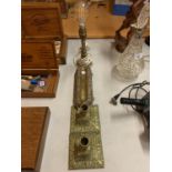 TWO BRASS CANDLESTICKS, A BRASS LAMP BASE AND A VINTAGE BRASS DESK ACCESSORY