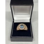 A 9 CARAT ROSE GOLD RING WITH A LARGE AQUAMARINE CENTRE STONE SURROUNDED BY TWELVE DIAMONDS WEIGHT