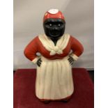 A VINTAGE CAST IRON MONEY BOX IN THE FIGURE OF A WOMAN