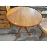 A CIRCULAR BEECH DINING TABLE