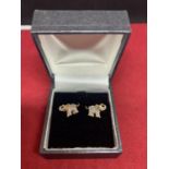 A BOXED PAIR OF 9 CARAT GOLD EARRINGS IN AN ELEPHANT DESIGN WITH CLEAR STONE CHIPS